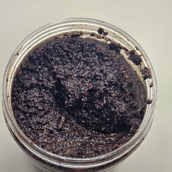 Coffee Sugar Scrub in jar — coarse exfoliating body scrub with natural coffee grounds for smooth, hydrated skin, opened to view the texture.