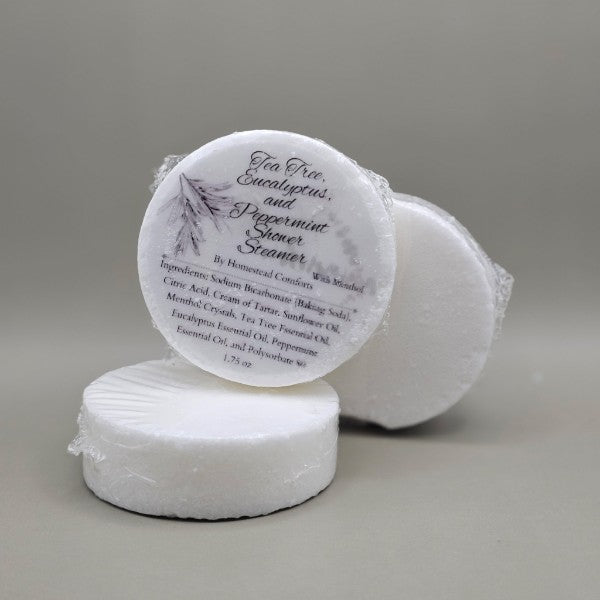 Invigorating Shower Steamers – handcrafted aromatherapy tablets infused with tea tree, eucalyptus and peppermint with menthol essential oils for a spa-like shower experience, available in multiple mood-enhancing blends.